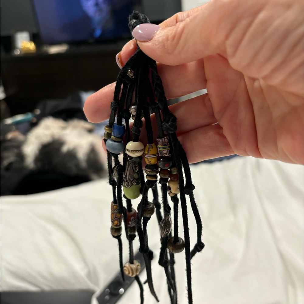 Lariat or open necklace with black leather and lots of charms